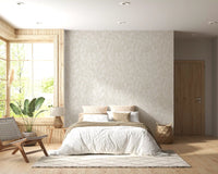 Beige botanical wallpaper used as a  bedroom accent wall. 