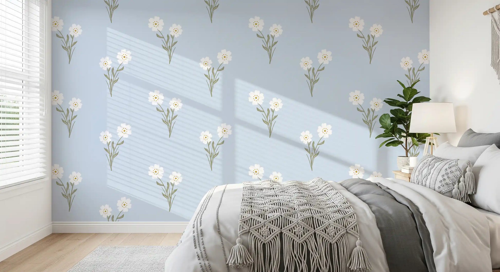Bedroom wall covered with pastel botanical bloom wallpaper and soft green leaf clusters.