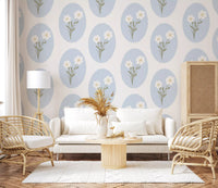 Floral repeat wallpaper with golden yellow daisy centres and sage olive green stems.