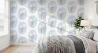 Bedroom wall featuring scalloped floral wallpaper with white daisies and blue oval frames.
