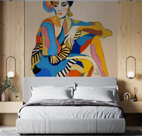 Bedroom accent wall with bold figurative wall mural of seated dancer in vibrant colours.