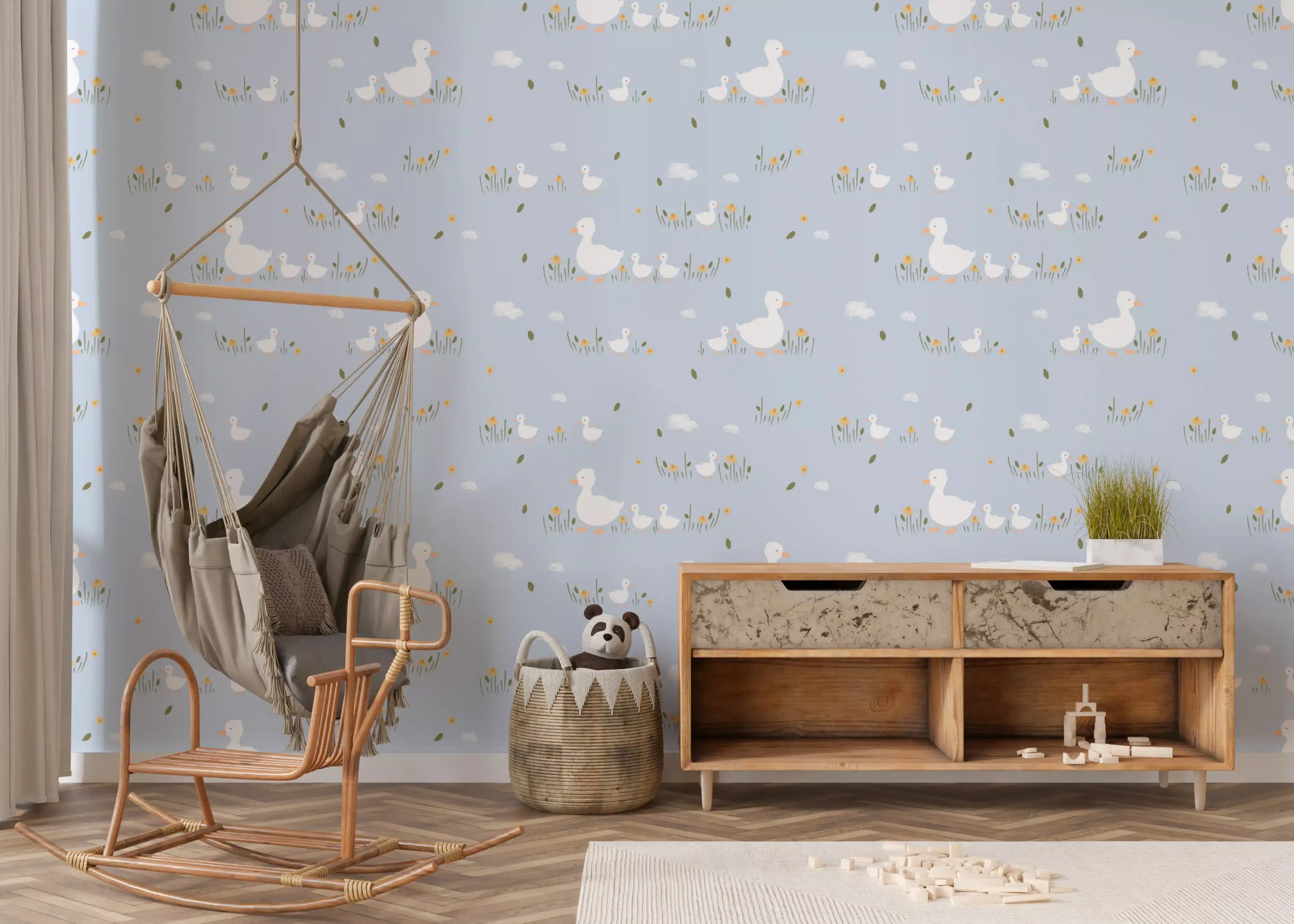 White ducks walking through grass with clouds on pastel blue wallpaper for nursery.