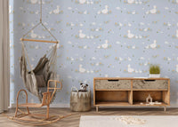 White ducks walking through grass with clouds on pastel blue wallpaper for nursery.