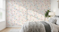 Bedroom wall covered in white background with peach blue blooms wallpaper.