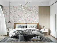 White background wallpaper with mixed flower shapes in master bedroom.