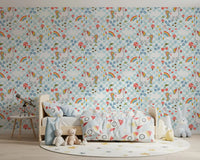 Multicolour unicorn pattern wallpaper with flowers, and pastel raindrops in child's bedroom.