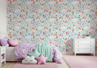 Soft blue chequered wallpaper with star, heart, and diamond motifs alongside unicorns.