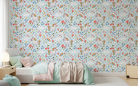 Pastel unicorn wallpaper with red toadstools, blue daisies, and tiny rainbow arcs in kids bedroom.