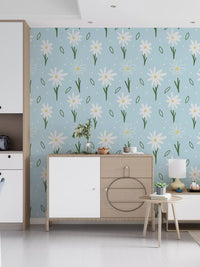 Blue wallpaper with daisy motifs, green stems and tiny scattered dots. 