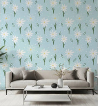 White daisies with yellow centres on a soft blue wallpaper in living room.