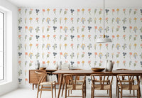 Pink poppy, navy cluster, and peach bud blooms with olive leaves wallpaper on white surface.