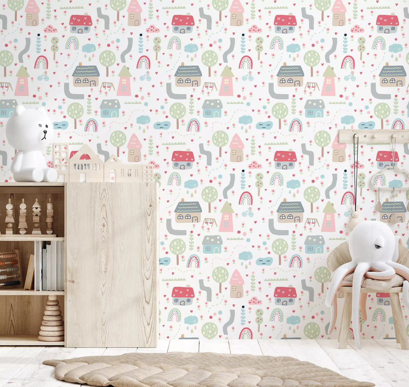 Baby village wallpaper installed in a soft pastel nursery wall scene.