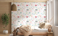 Bedroom feature wall with houses trees rainbows and clouds pattern wallpaper.