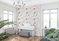 Whimsical illustrated village motif wallpaper in pink sage green and sky blue tone.