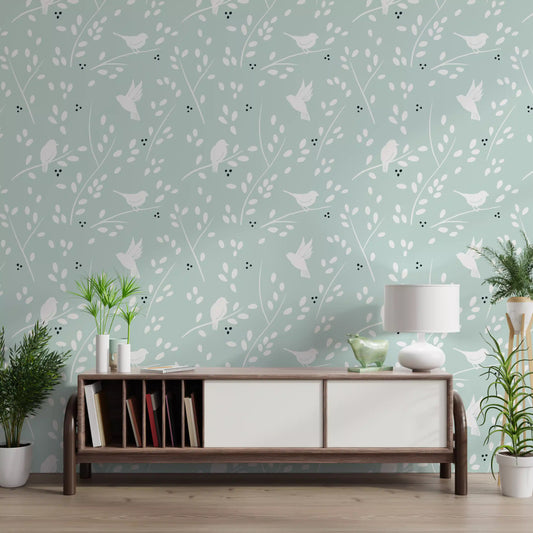 White birds and slender branches on a soft mint-green wallpaper in hallway.
