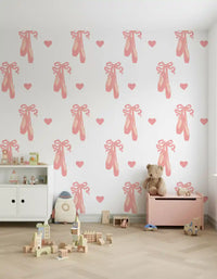 Scattered hearts and ballet shoes wallpaper forming a gentle pastel pattern in playroom.