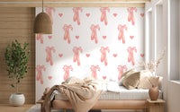 Bedroom wallpaper showing pink ballet shoes, hearts and ribbon bows. 
