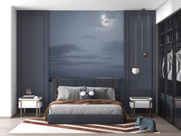 Moonlit ocean mural on a bedroom feature wall in cool blue tones.