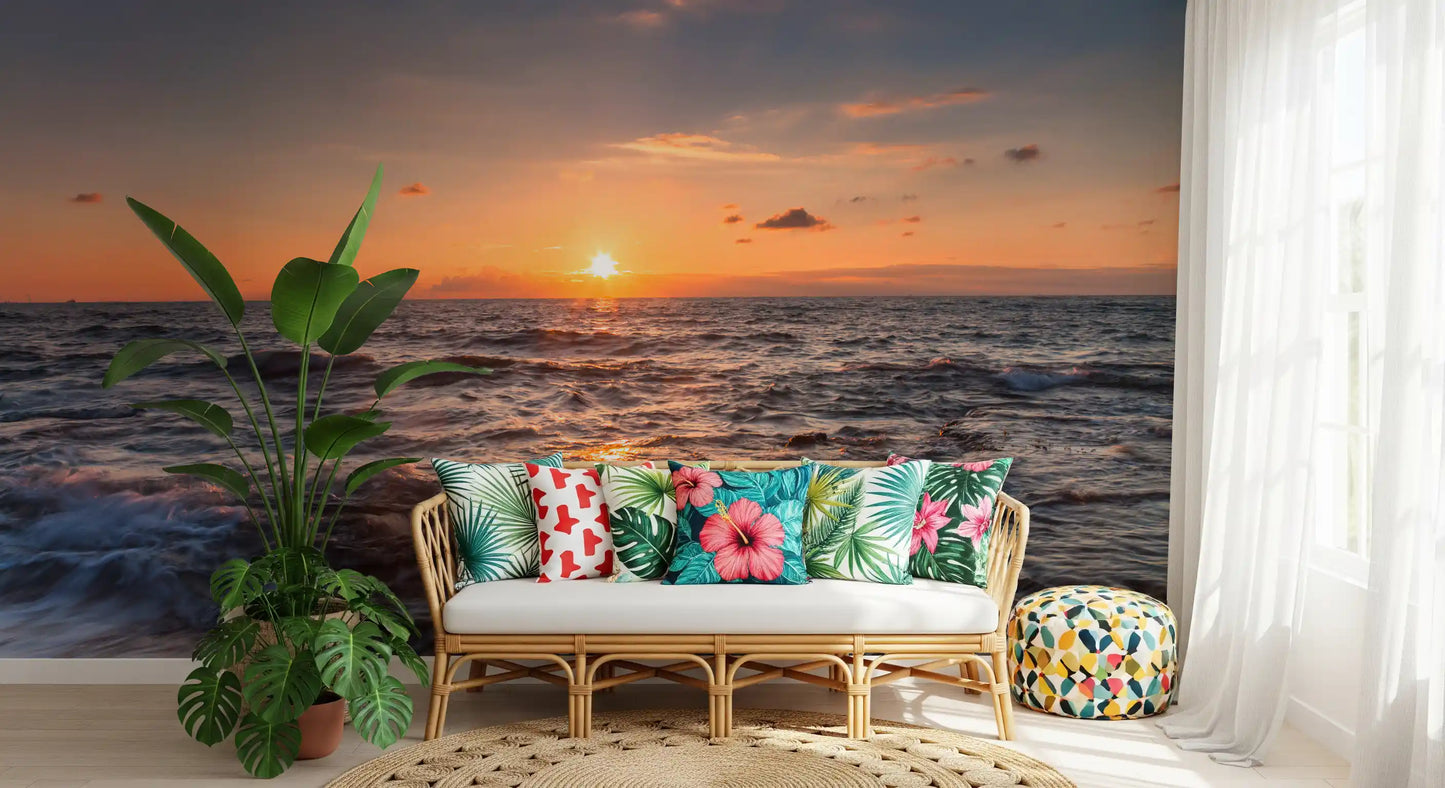 Wide seascape wall mural with the sun resting low over open water and warm amber clouds.