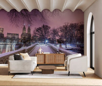 Winter landscape mural with a snowy path leading across Bow Bridge.