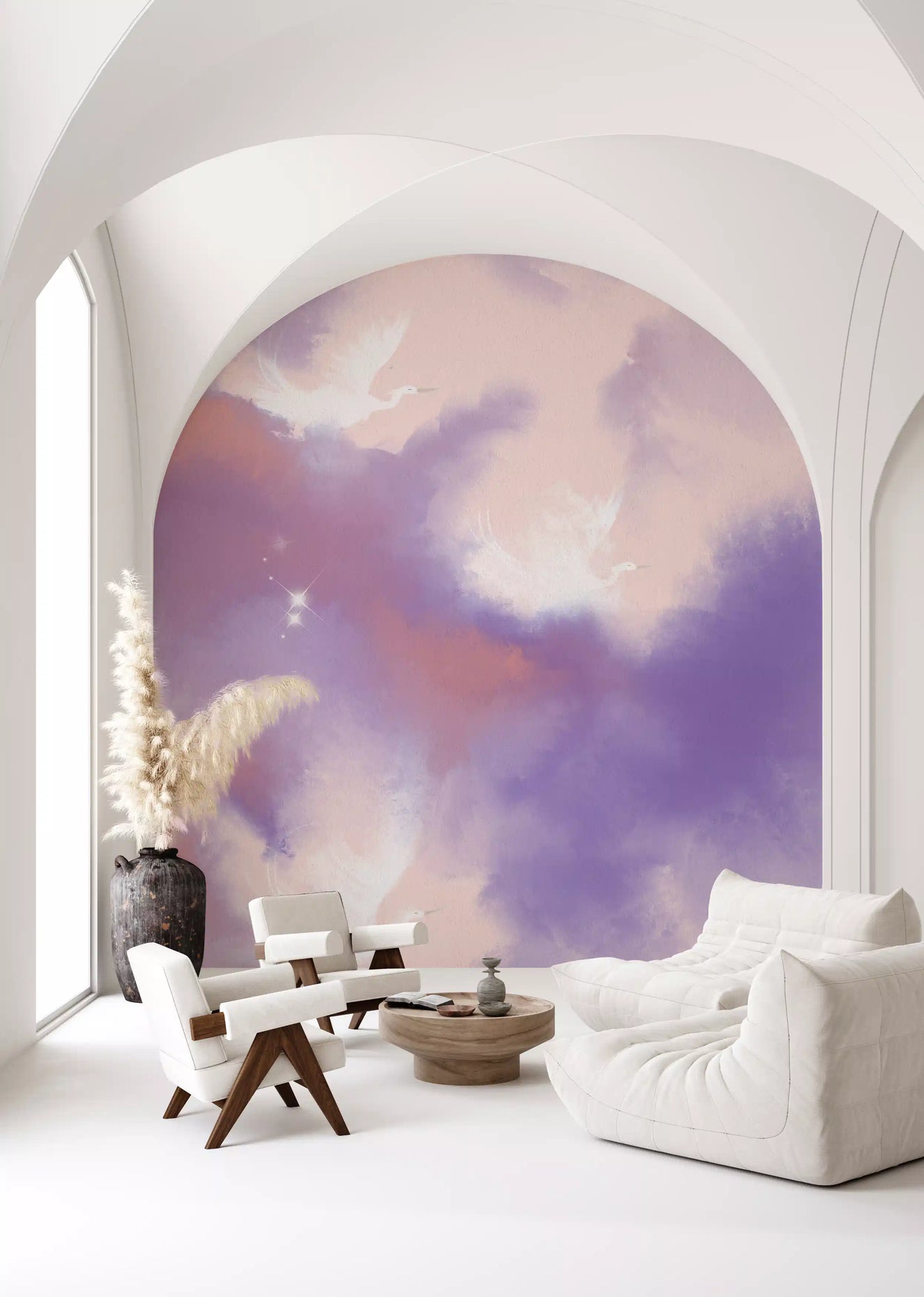 Watercolour bird mural showing slender cranes mid-flight among soft peach clouds. 