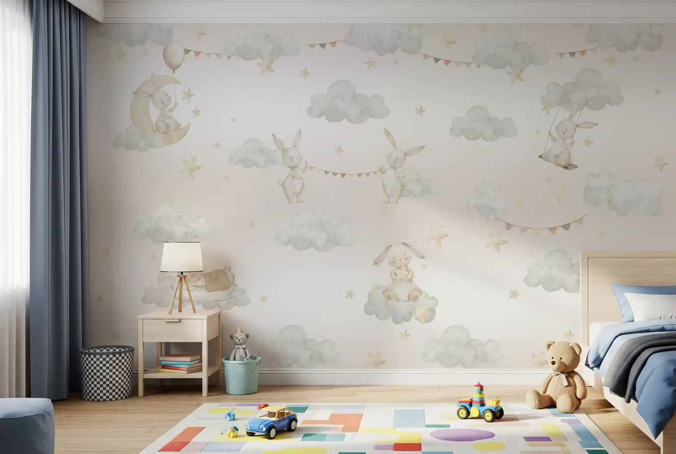 Bunny cloud mural on a bedroom wall with rabbits, soft grey clouds and cream stars. 
