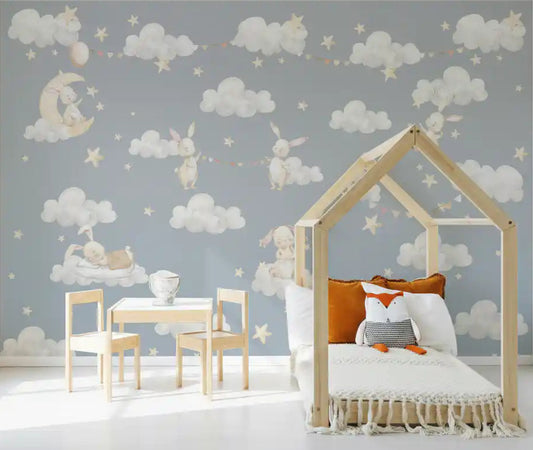Dreamy bunnies and clouds mural covering a toddler room feature wall 