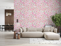 Living room wall styled with a pink watercolour daisy wallpaper on a white background., GD10217
