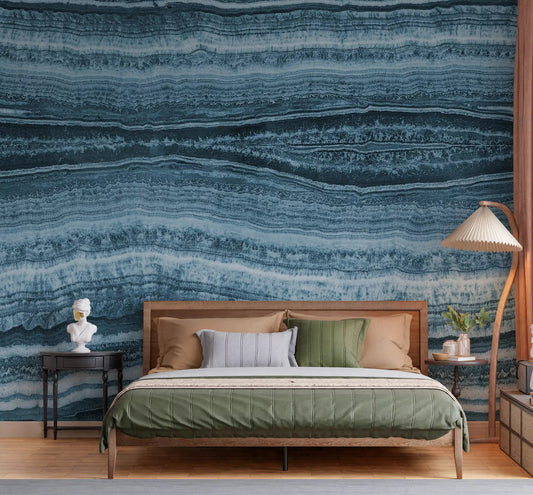 Blue marble layered mural used as a headboard wall in a bedroom.