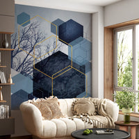 Grey and blue wall mural featuring sharp geometric patterns and trees.