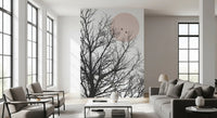 Bare tree branch wall mural with two birds perched under a soft blush sun., GD10289