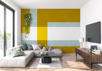 Layered block wall mural with translucent overlaps in golden olive and sage tones.