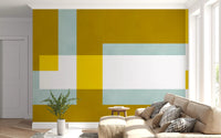 Abstract wall mural in golden olive with overlapping pale mint and lemon blocks.