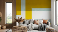 Layered abstract wall mural with mustard, sage, white and bright lemon blocks.