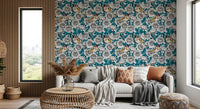 Bold teal botanical foliage wallpaper with red-brown stems in living room.