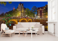 Urban waterfront wall mural with brick townhouses and leafy green trees., GD10420