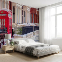 Red phone booth in snow beside brick terraced houses mural., GD10423
