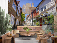 Cobblestone street wall mural with Red doorway and dark shopfront frames., GD10426