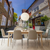 Cobbled street mural with aged brickwork and painted plaster walls in dining room., GD10426