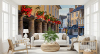 Village wall mural with Cascading red and pink blooms above stone archway., GD10427