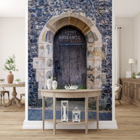 Pointed stone archway mural featuring aged timber door and iron latch., GD10450