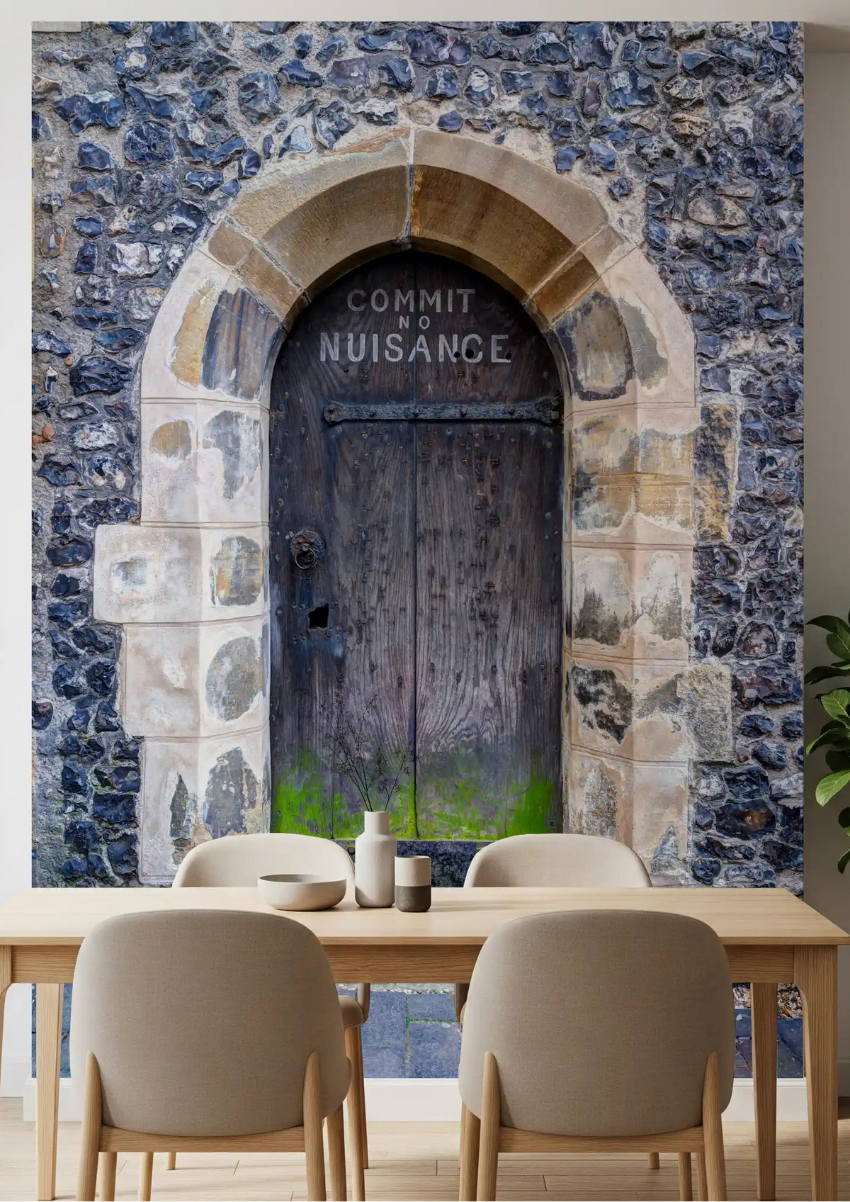 Vintage stone door wall mural displayed in a dining room space with flint stone., GD10450