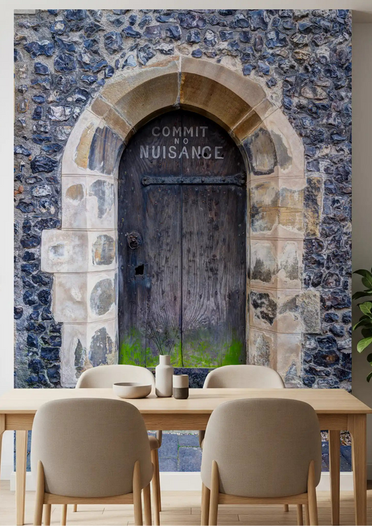 Vintage stone door wall mural displayed in a dining room space with flint stone.
