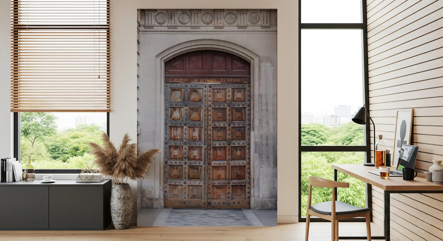 Carved grey stone archway framing wooden doors in historic portal wall mural., GD10463