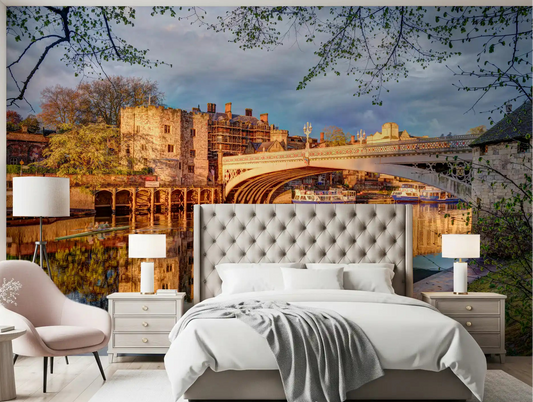 Golden river reflection cityscape wall mural featured in a bedroom setting.
