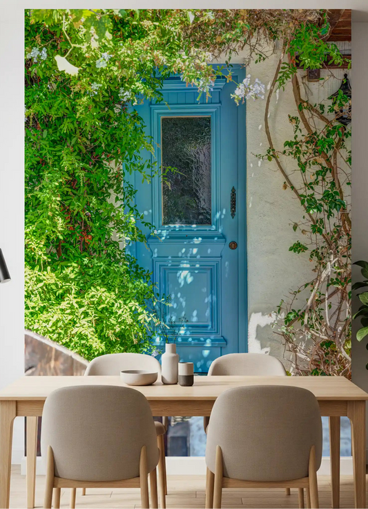 Blue cottage door wall mural adding warmth to a dining room interior space