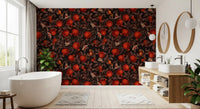 Red fruit and butterfly pattern wallpaper on deep black background in bathroom.