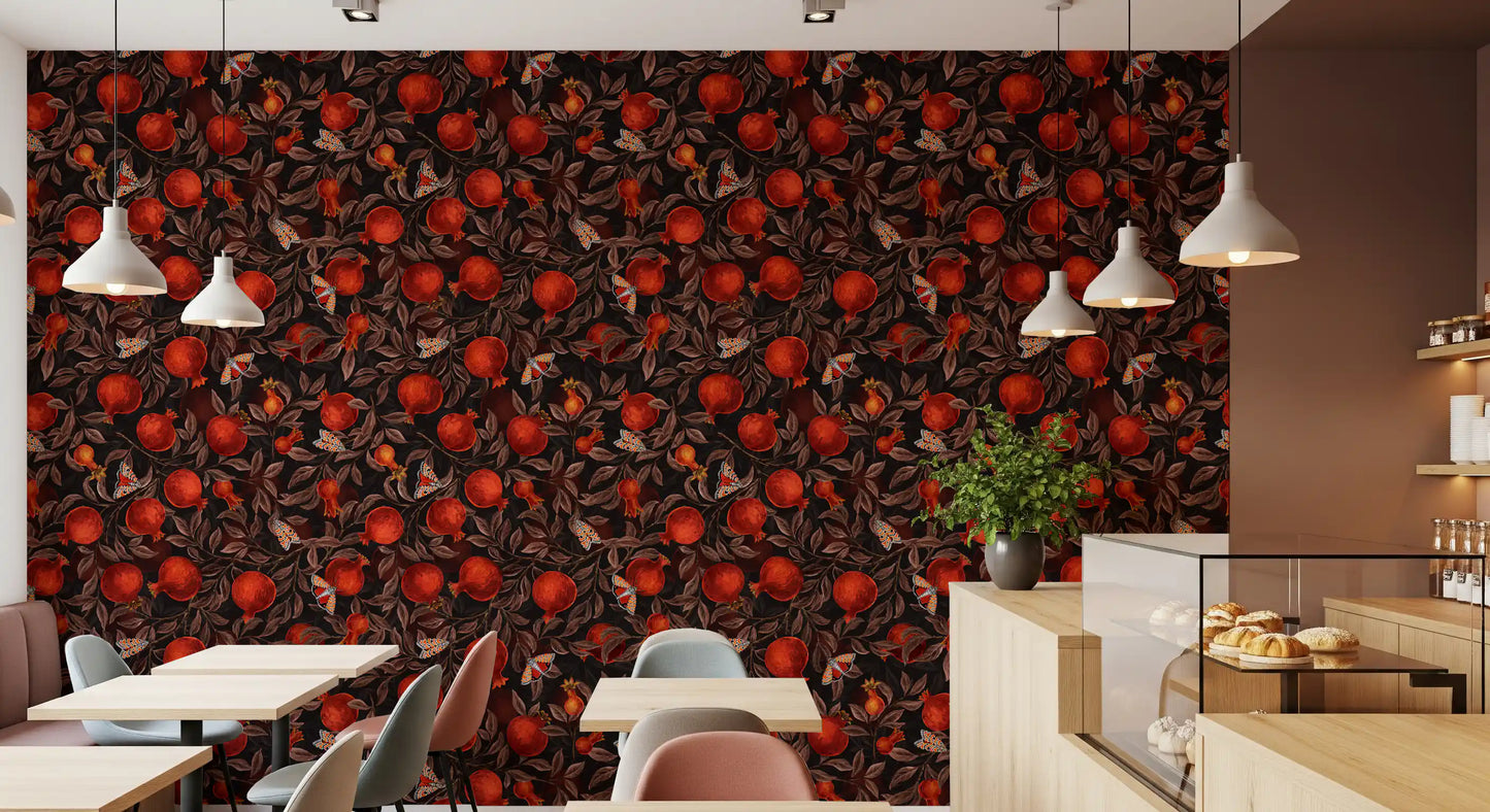 Cafe wallpaper with red pomegranates on black background and dark leaves.