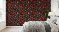 Red fruit and moth pattern wallpaper on deep black background in bedroom.