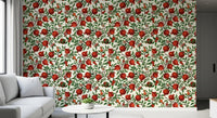 Crimson pomegranate fruit wallpaper with winding brown branches and green foliage.